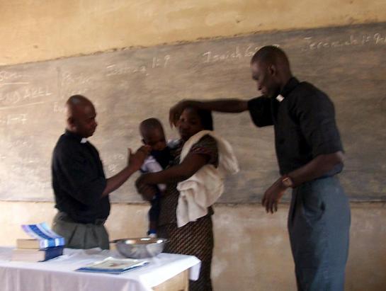 Vicar Ernest Baptising his son.